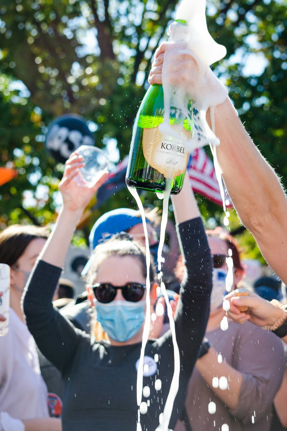 man in white shirt holding green bottle