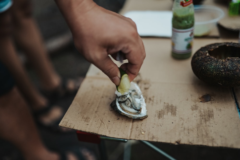 person holding a sliced of cake