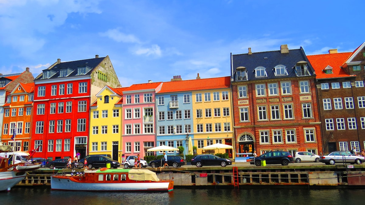 Copenhagen March — Nyhavn harbour with colourful townhouses and boats along the canal waterfront
