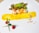 A gourmet dish is artistically presented on a white plate. Scallops, garnished with a bright orange sauce, are accompanied by a leafy green salad. A smear of vibrant yellow sauce runs across the plate, and scattered pine nuts add texture. Two red raspberries and a blueberry are positioned artfully alongside two thin green chives.