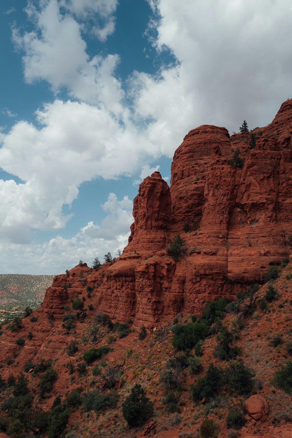 brown rock formation under blue sky and white clouds during daytime