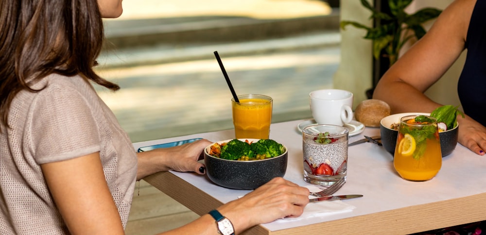 person holding black ceramic bowl with vegetable salad