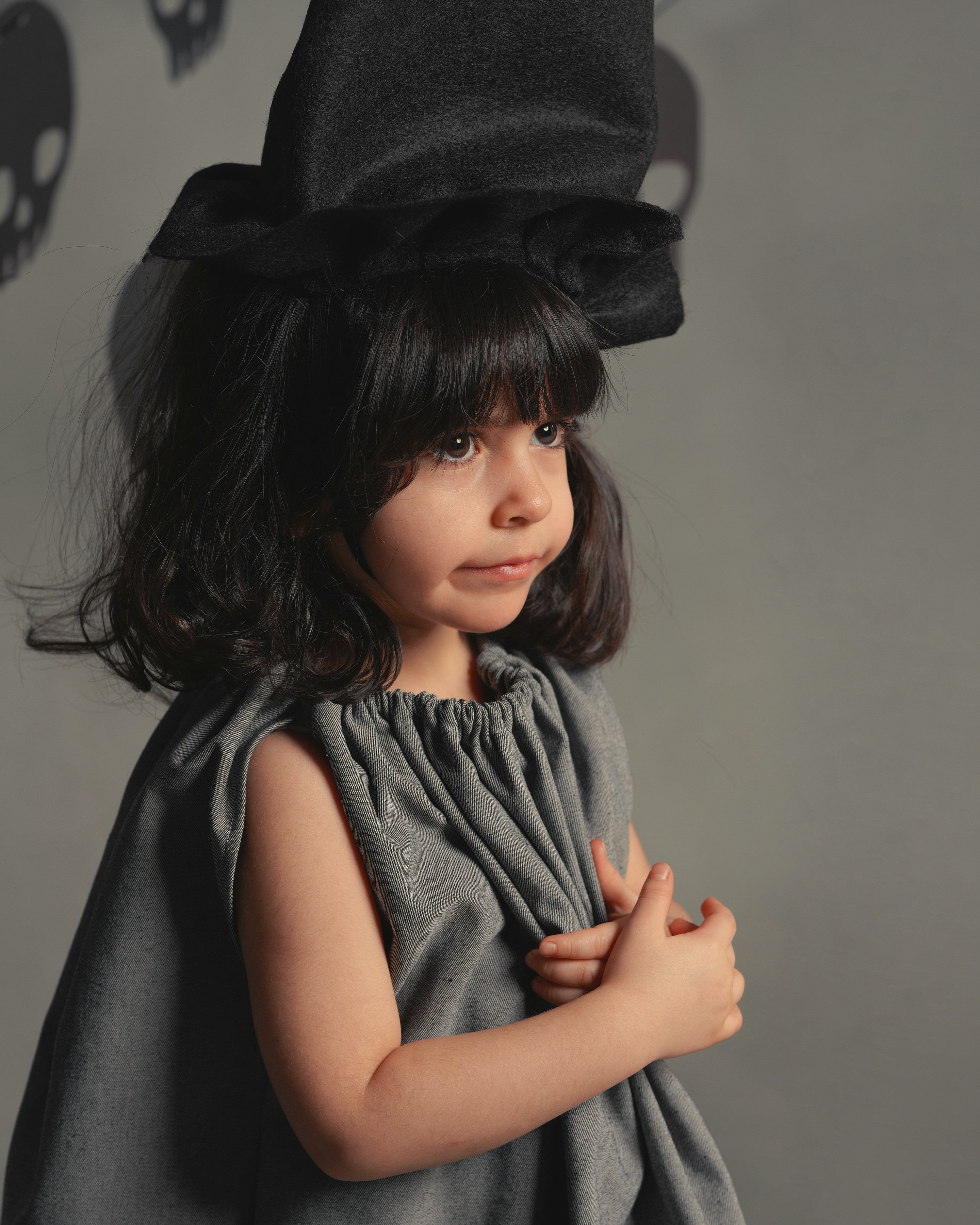 woman in black hat and gray and black stripe shirt