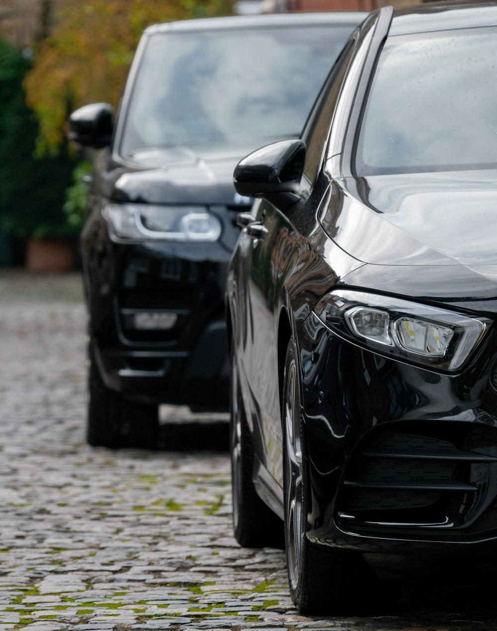 black mercedes benz c class parked on gray pavement during daytime