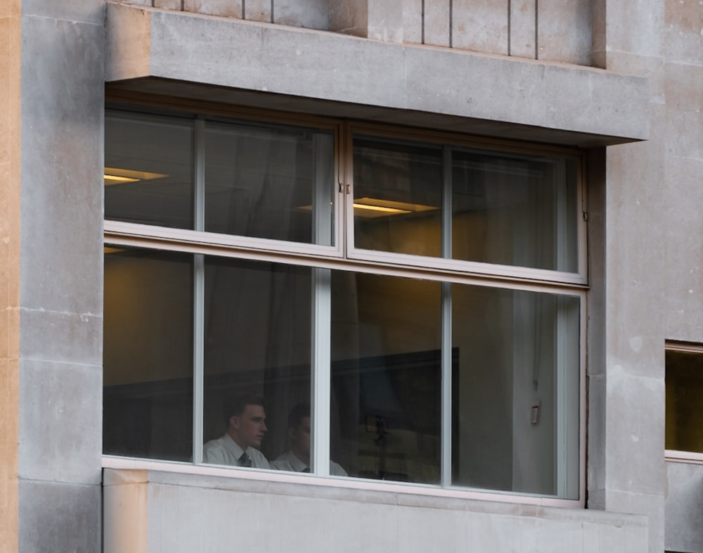 a man is looking out of a window