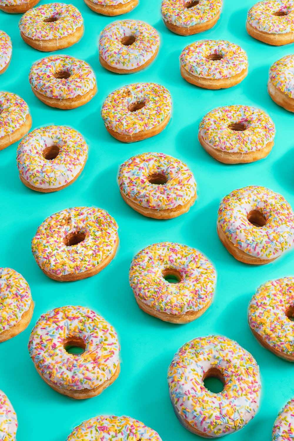 rosquillas blancas y rosadas sobre superficie blanca