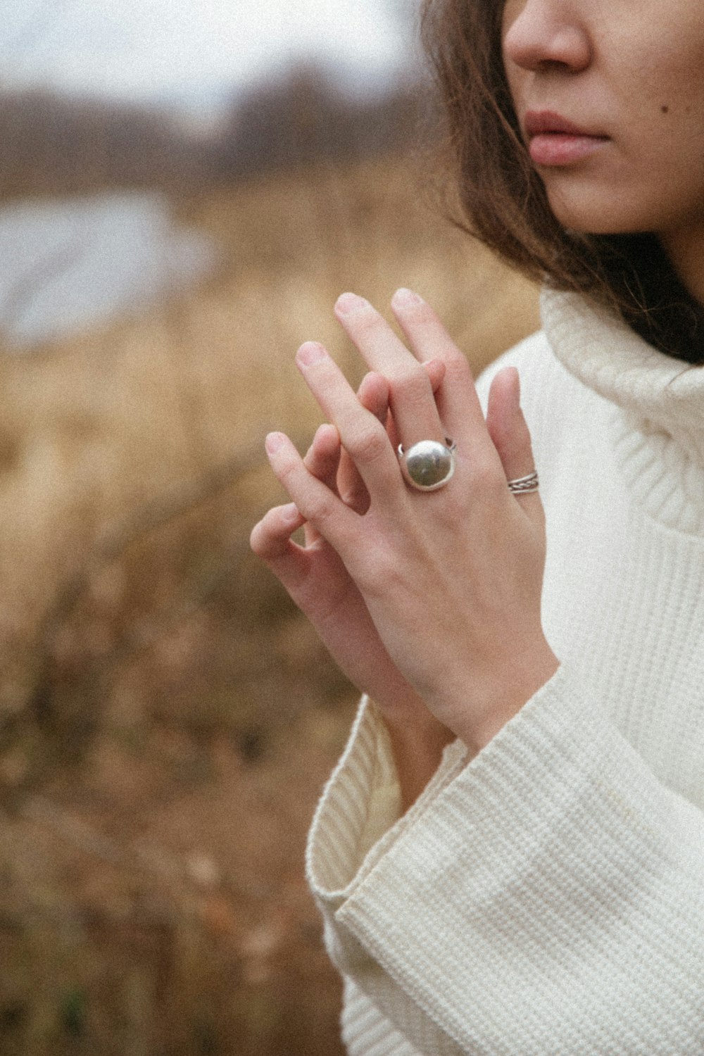 woman wearing silver ring with purple gemstone