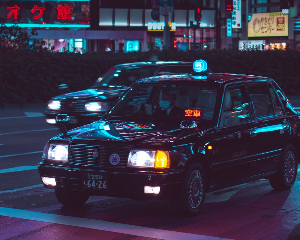 black car on the street during night time