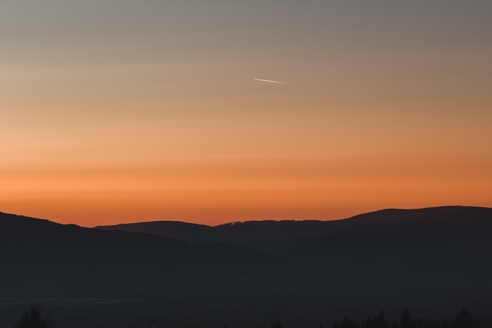 silhouette of mountains during sunset