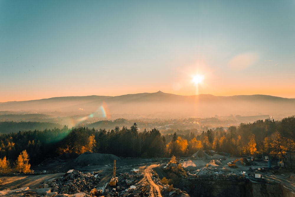 green trees and mountains during sunrise