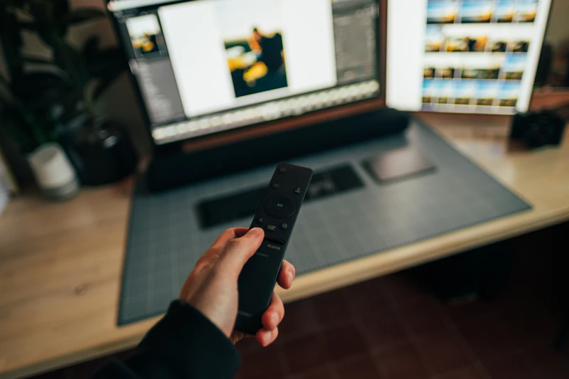 A person holding a TV remote control