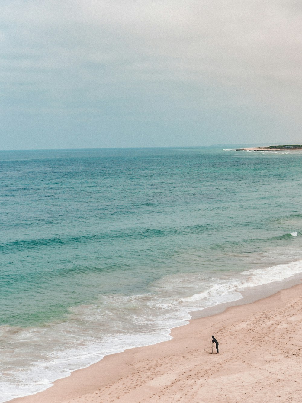 person walking on beach during daytime