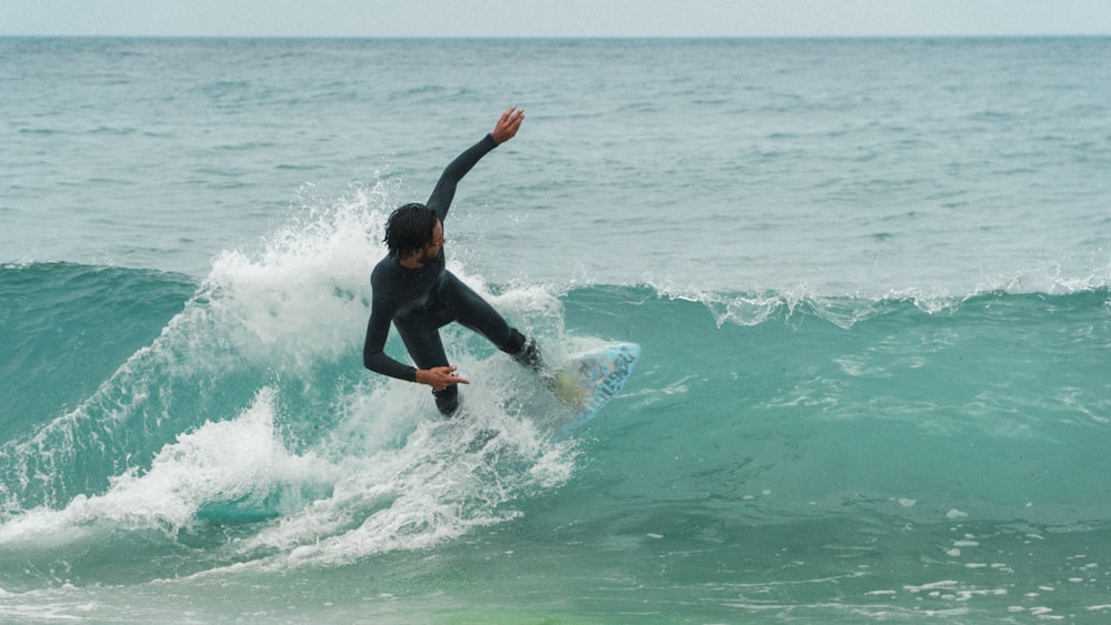 man surfing on sea waves during daytime