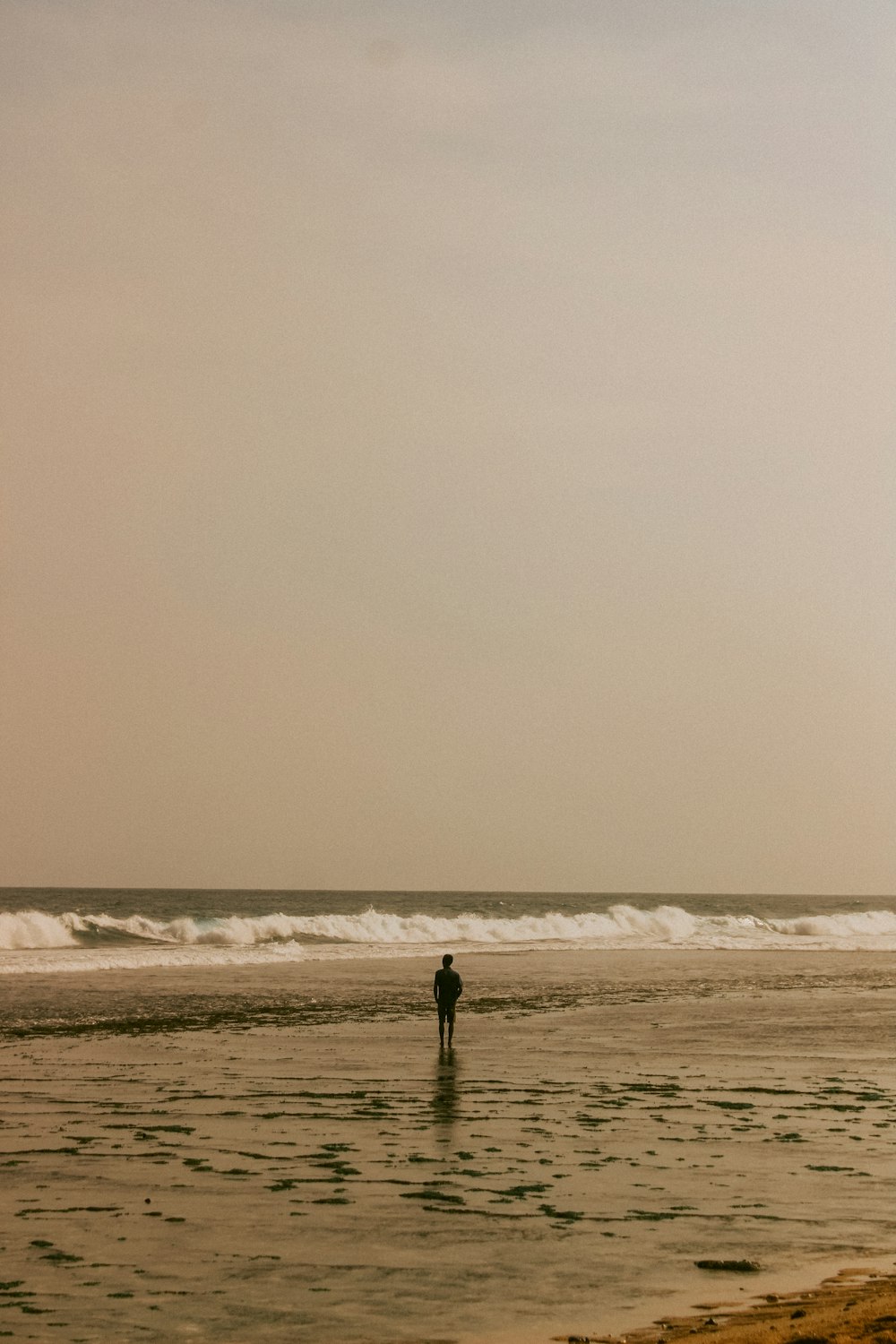 person walking on beach during daytime