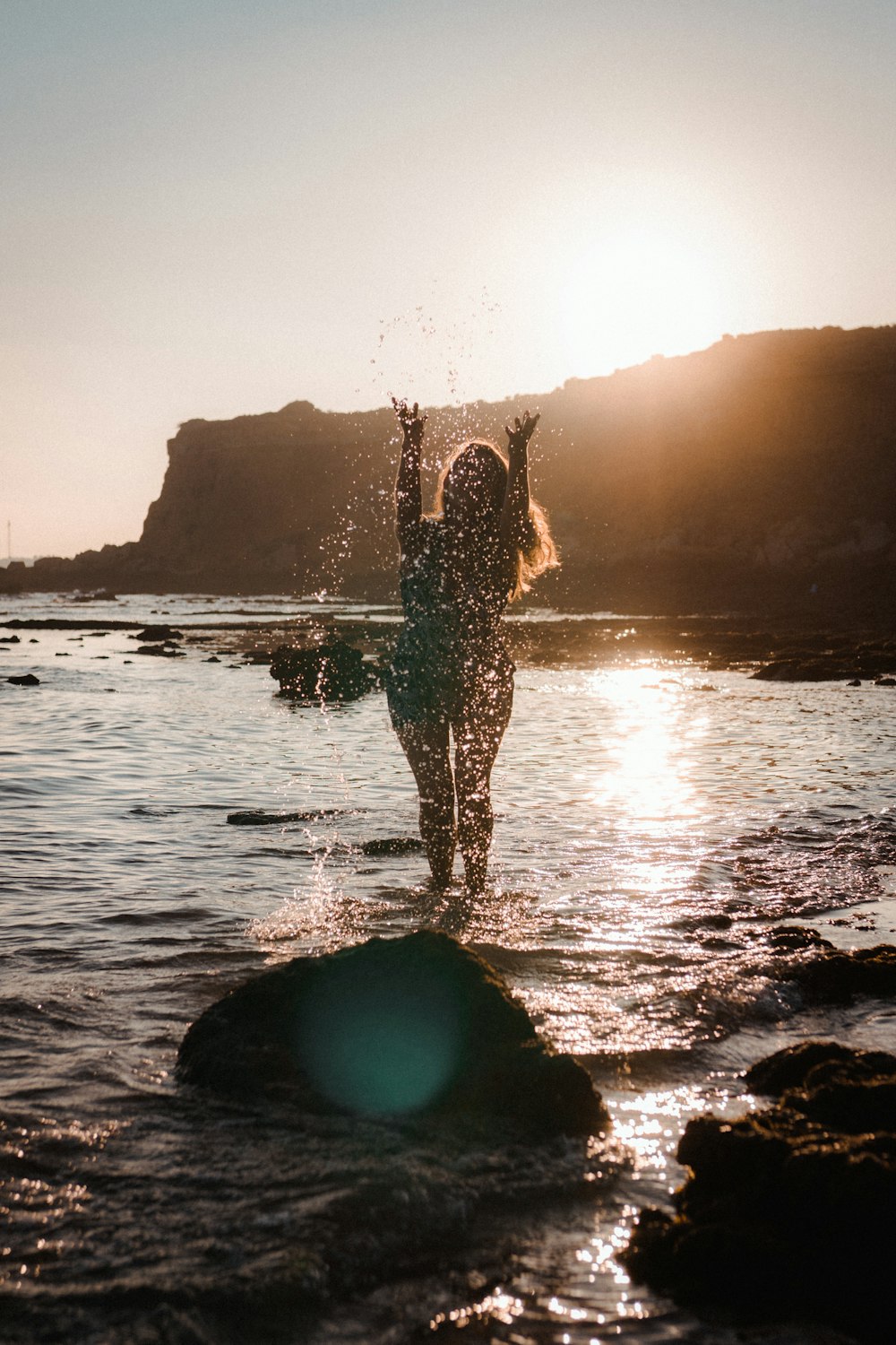 woman in black and white dress standing on water during daytime