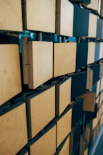 brown cardboard boxes on blue steel rack