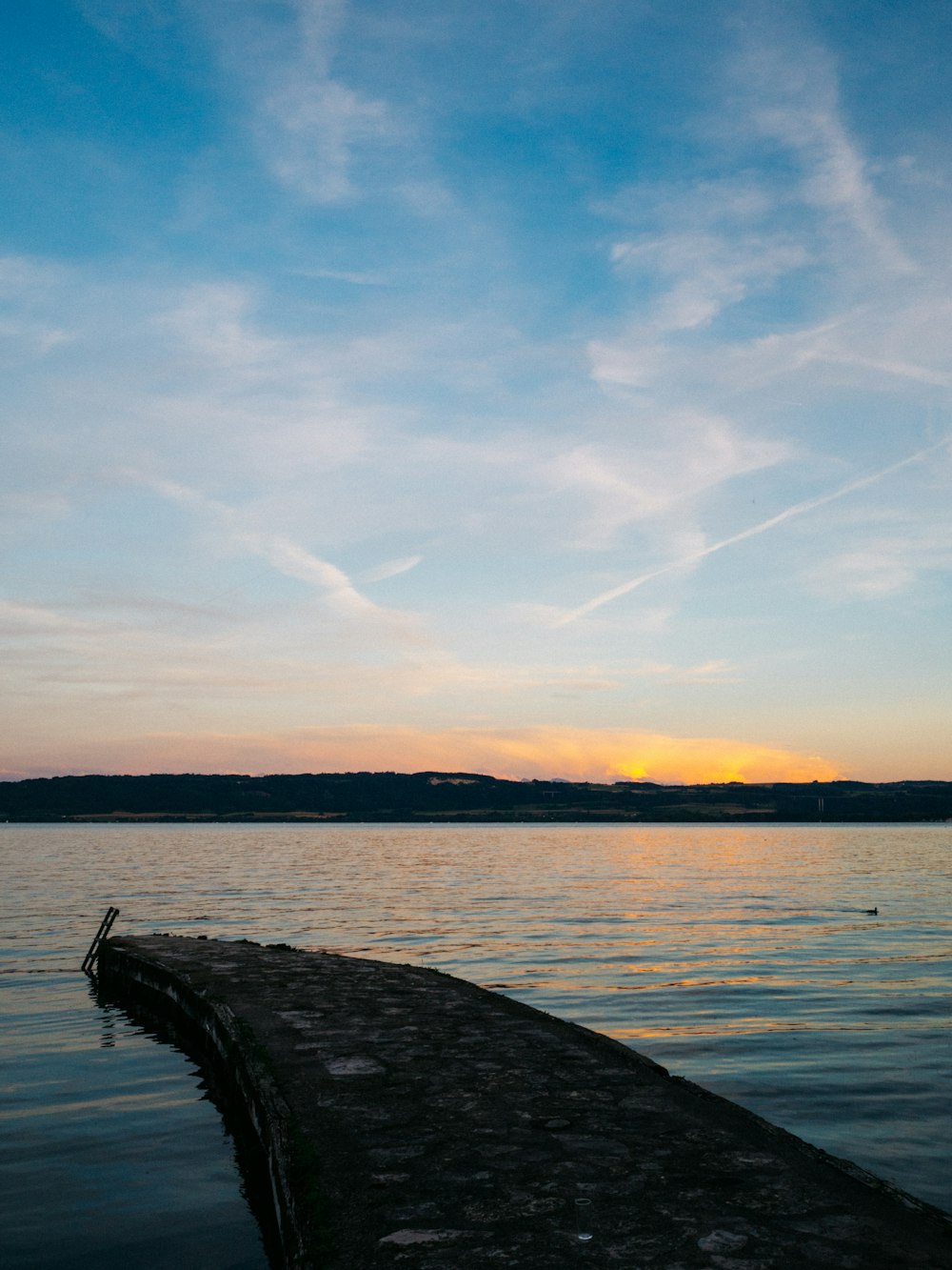 body of water under cloudy sky during daytime