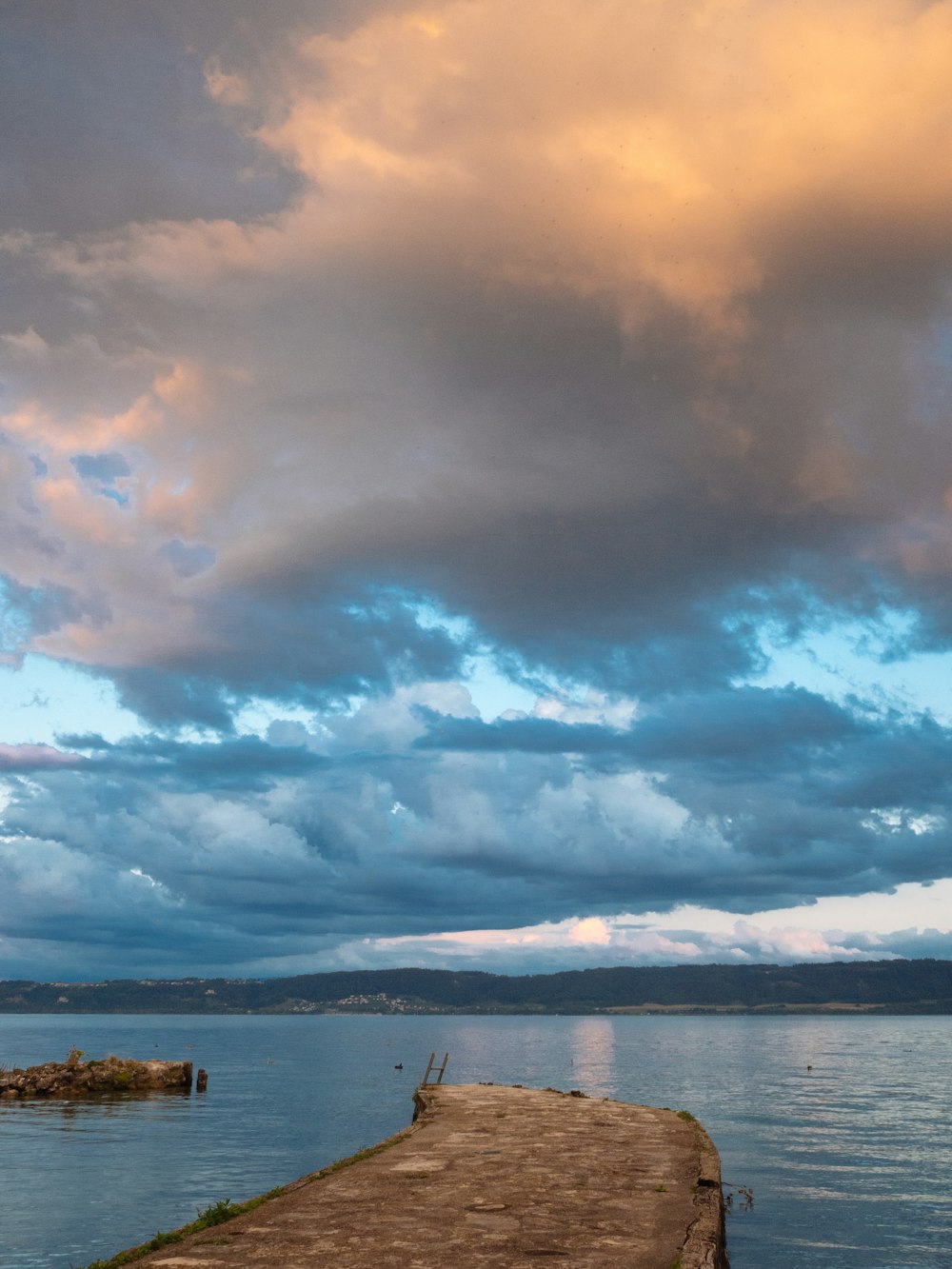 body of water under cloudy sky during daytime