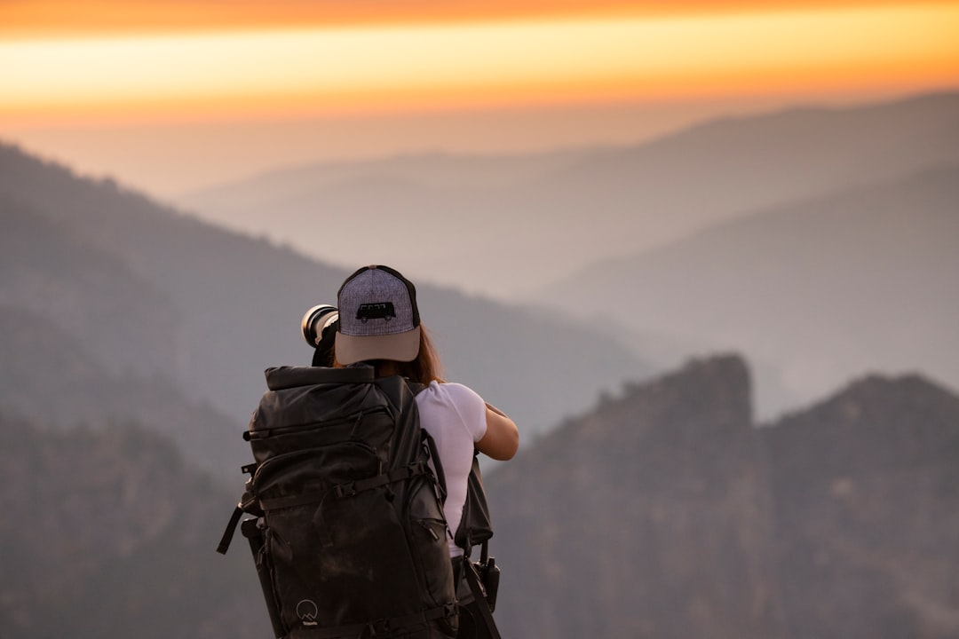 person in black and white helmet and black backpack