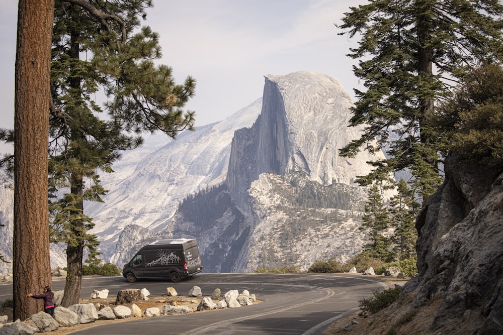 black suv on road near mountain