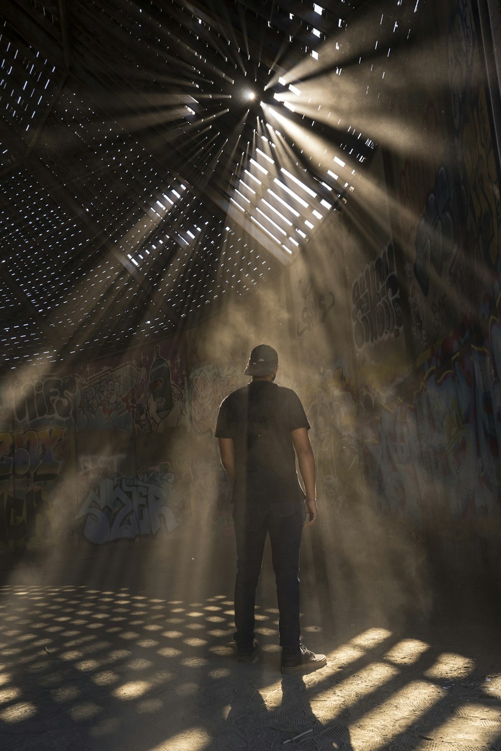 man in black shirt standing on tunnel