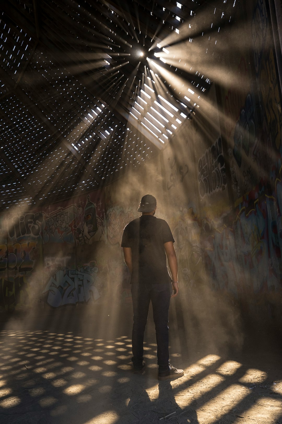 man in black shirt standing on tunnel