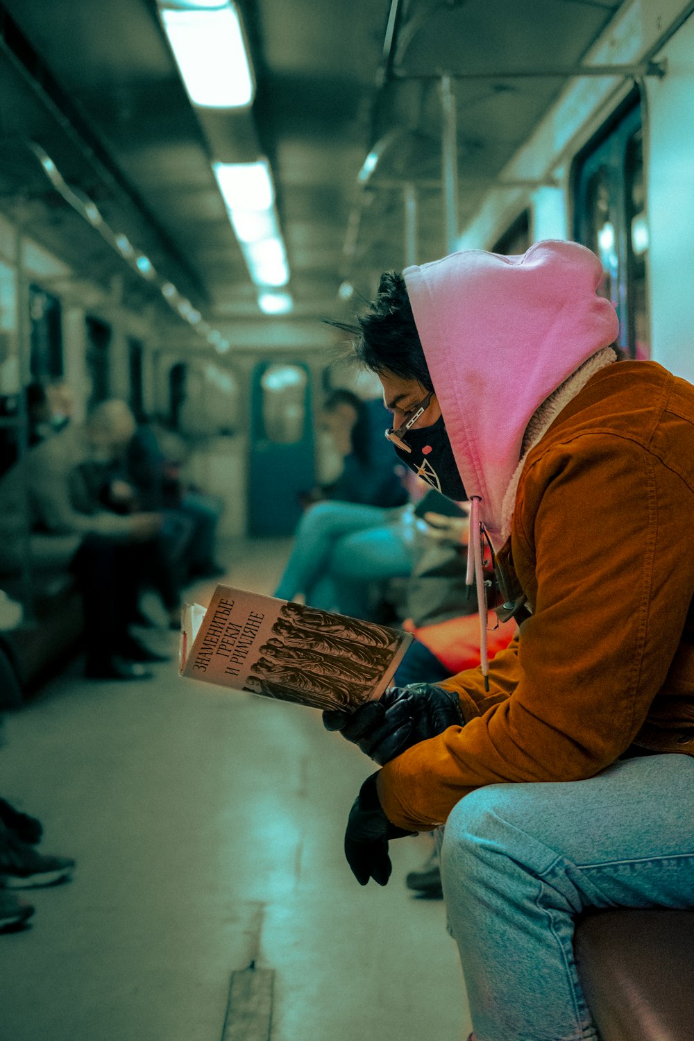 woman in brown hoodie reading book