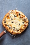 pizza on brown wooden round tray