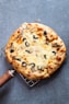 pizza on brown wooden round tray