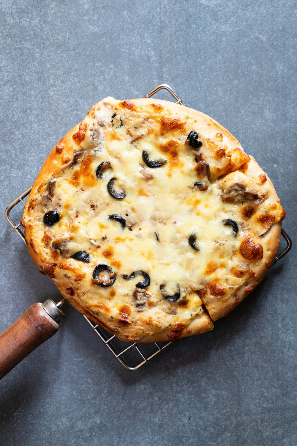 pizza on brown wooden round tray