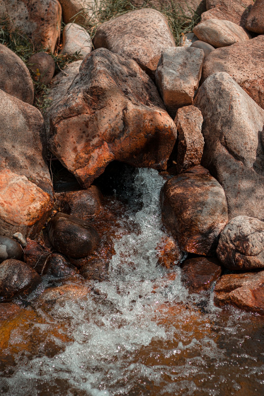 brown and gray rocks on water