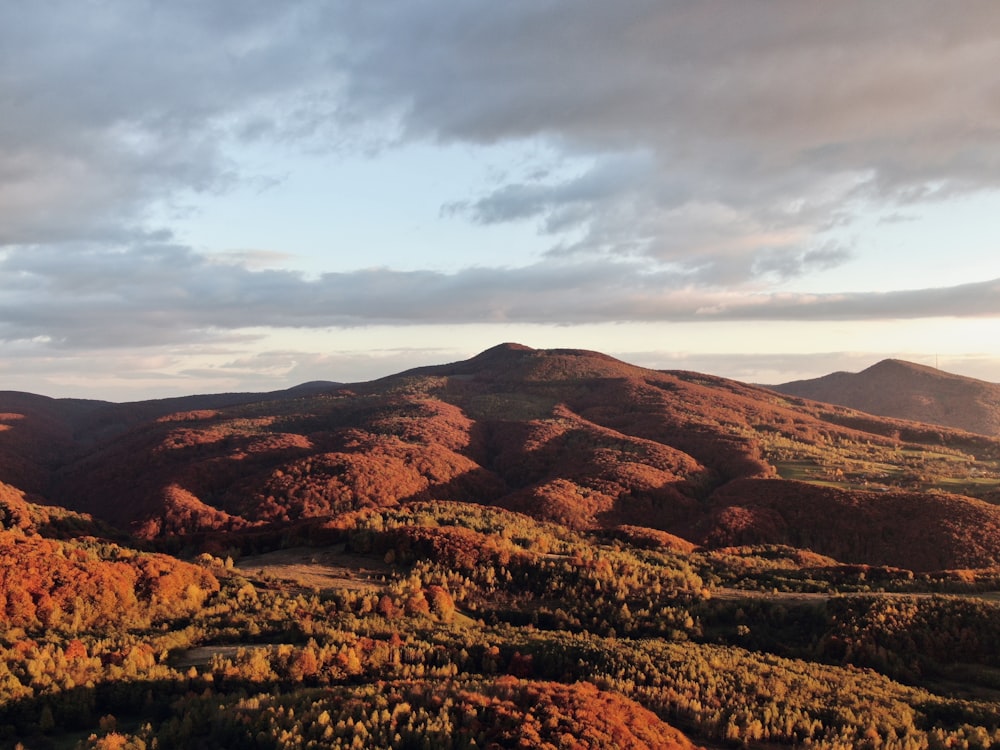 brown mountains under white clouds during daytime