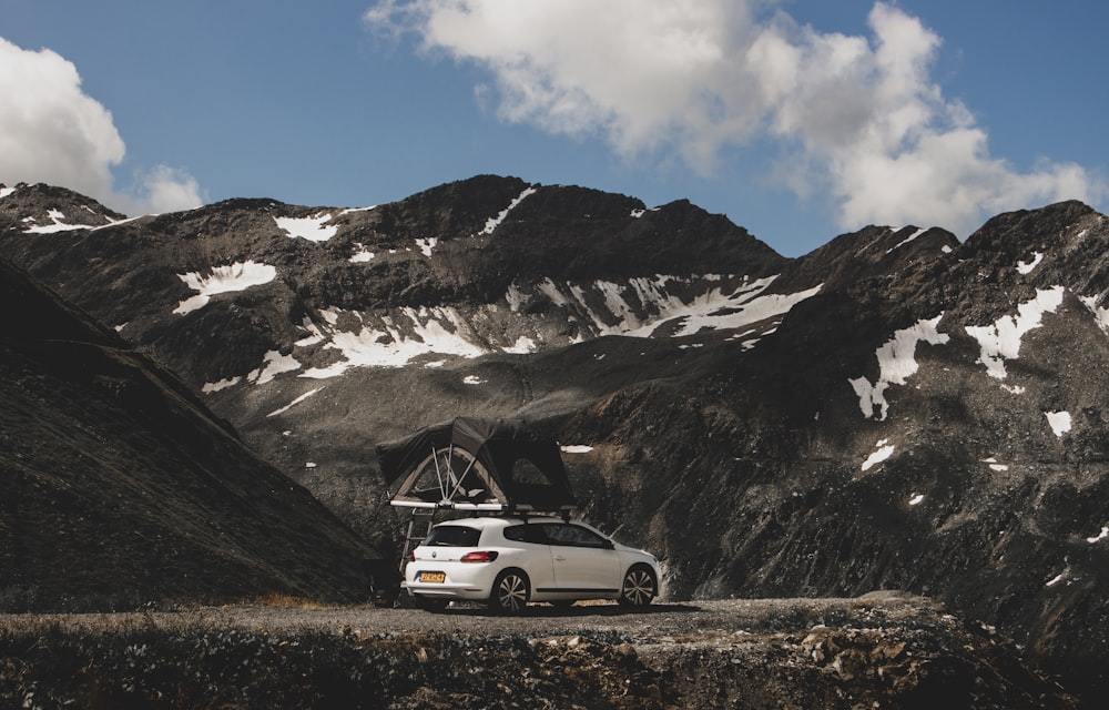 white suv on road near snow covered mountain