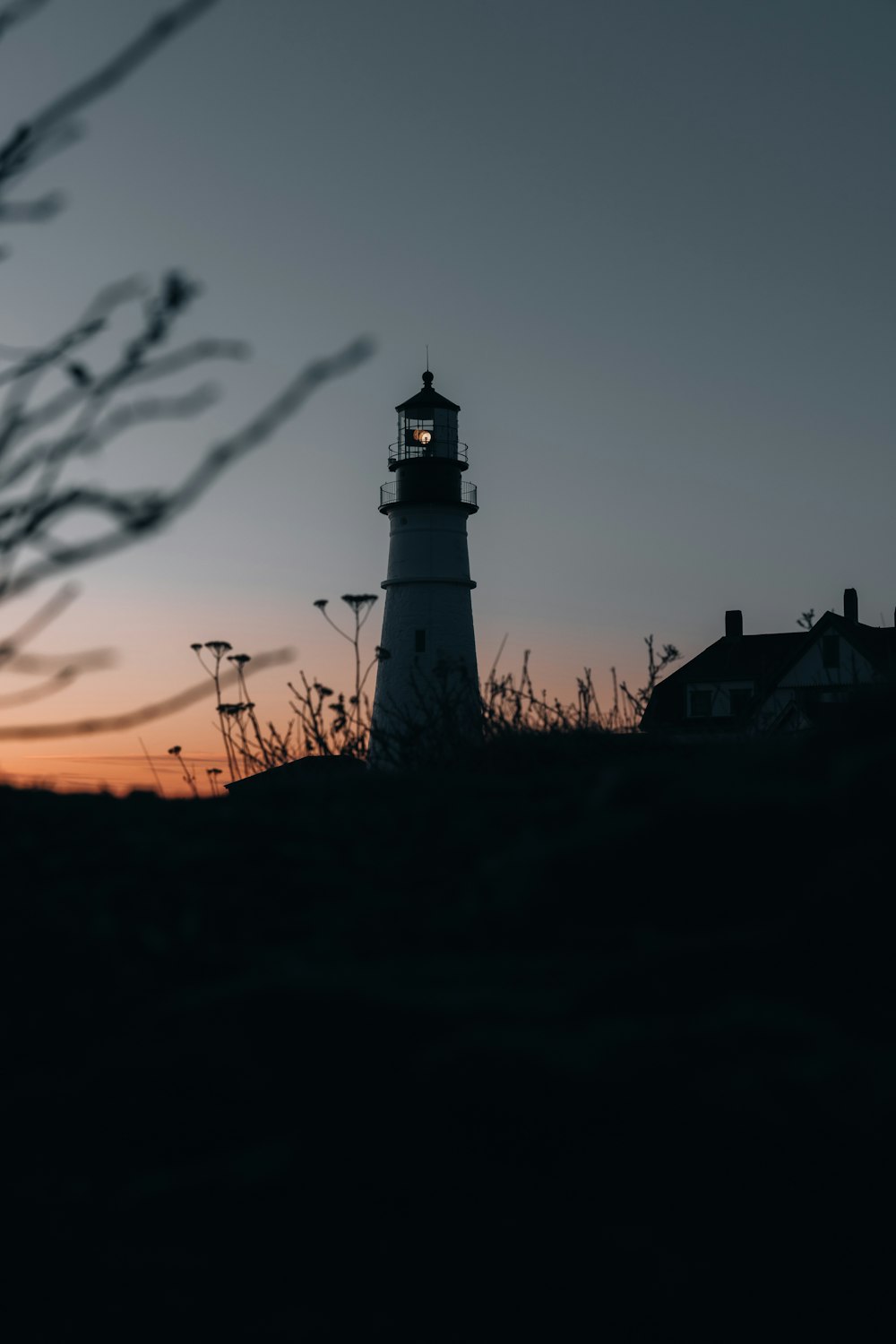 silhouette of lighthouse during sunset