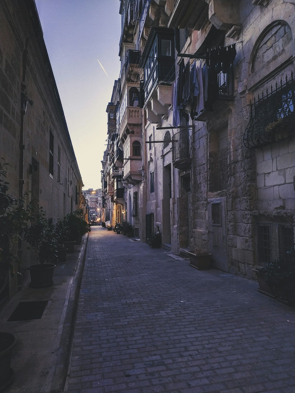 gray concrete road between buildings during daytime