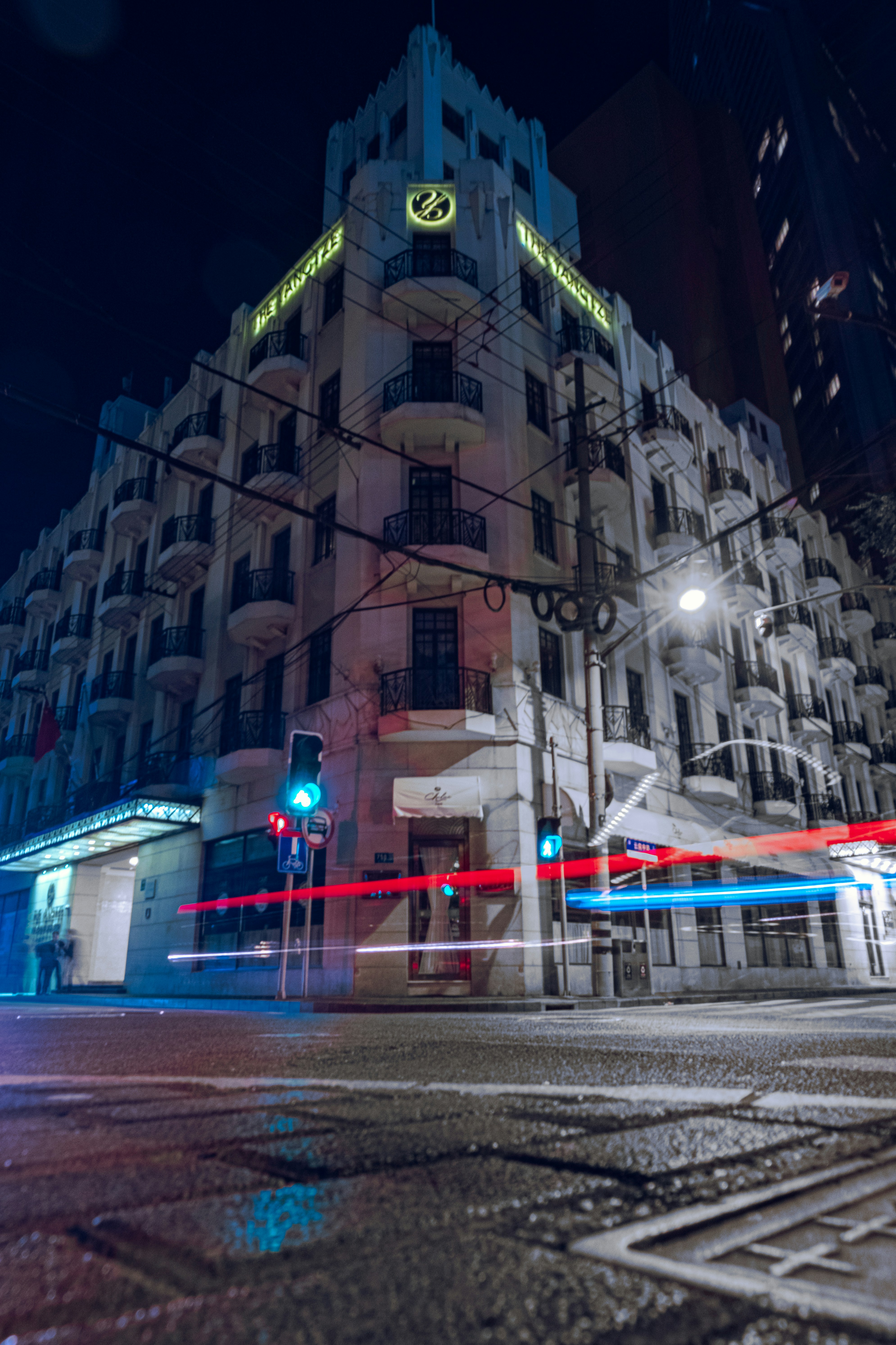 time lapse photography of cars on road near building during night time