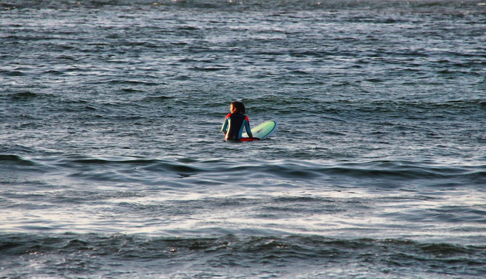 person surfing on sea during daytime