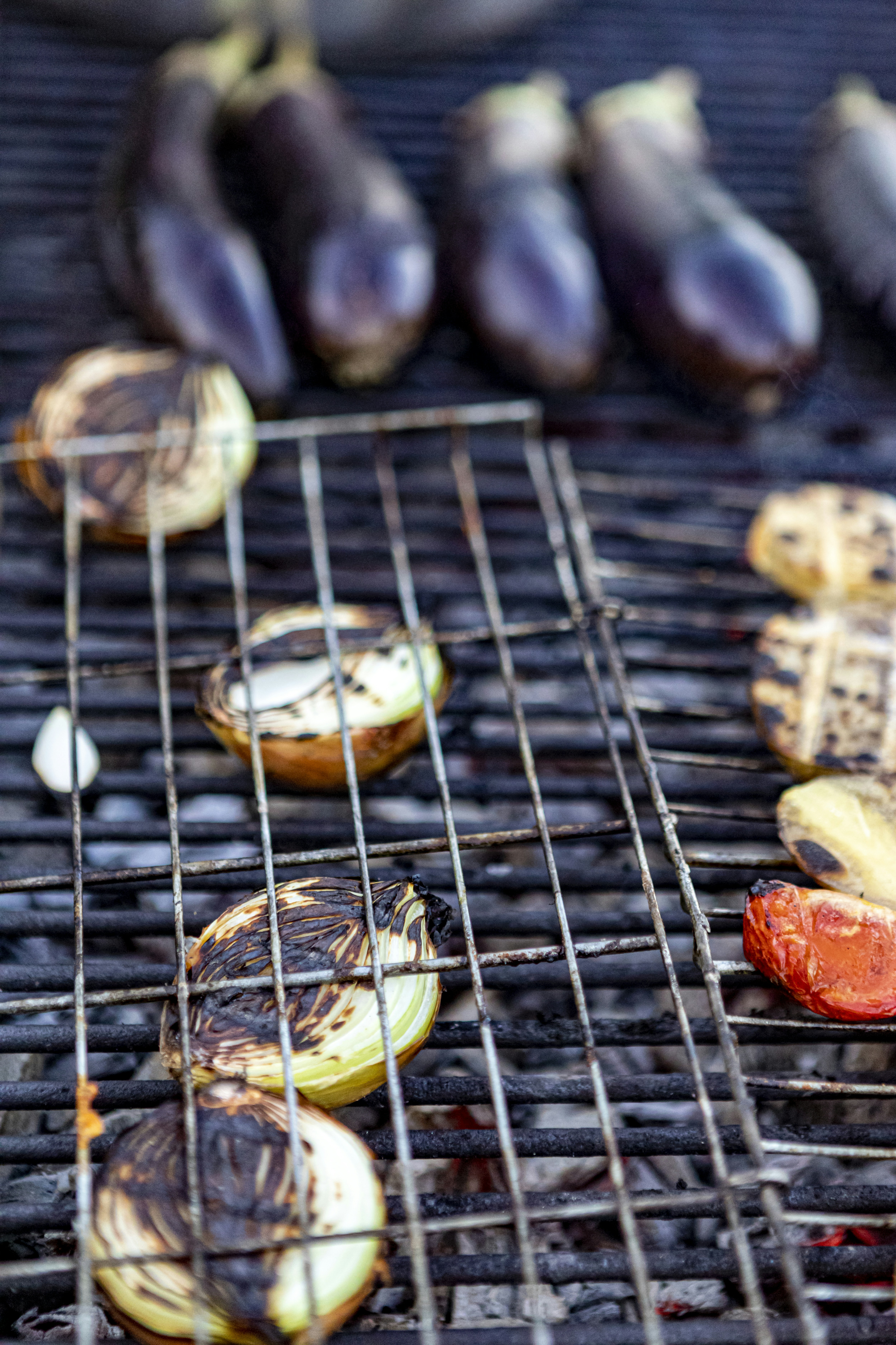 sliced bananas and red apple on black metal grill