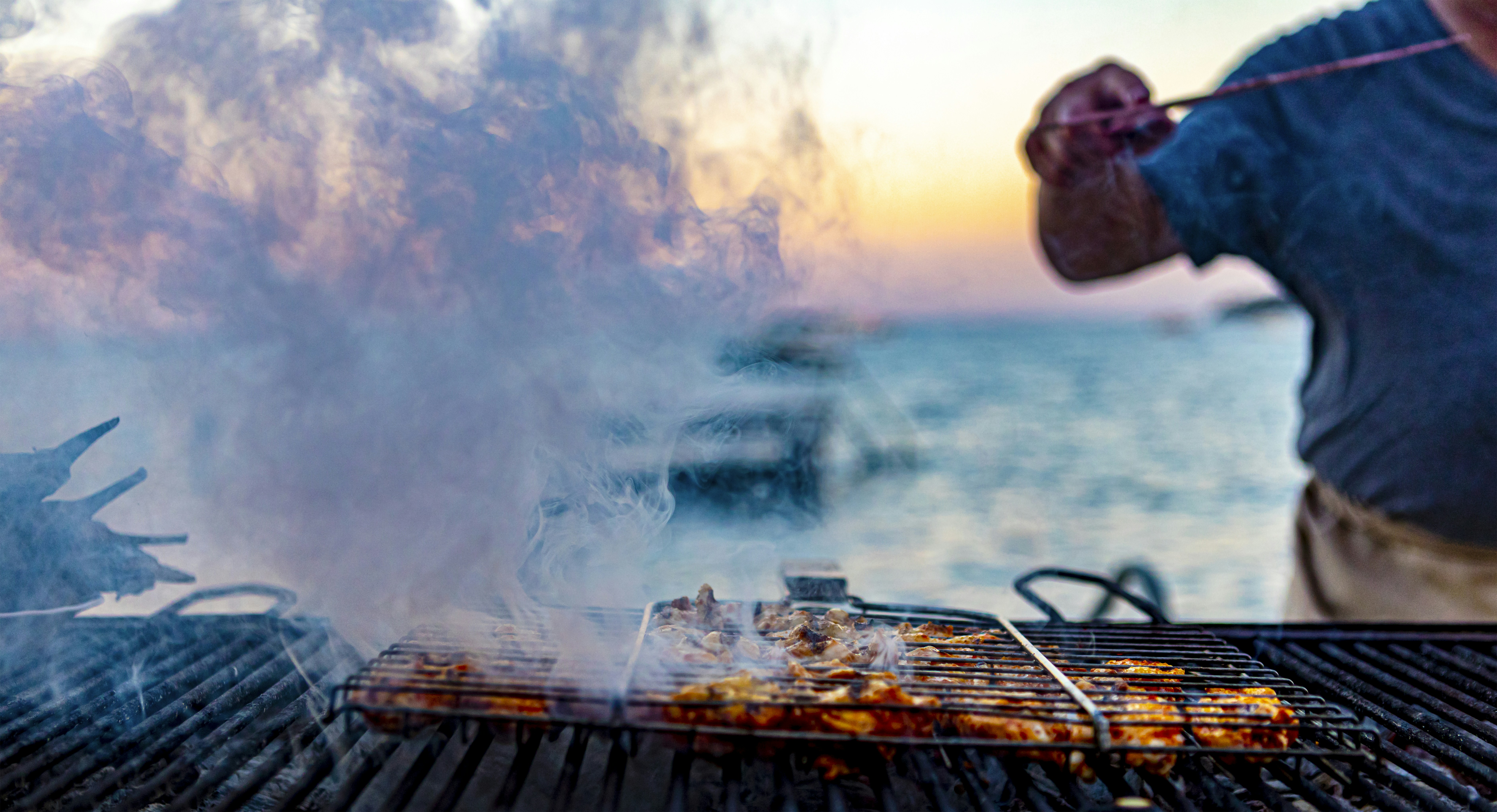 man in black jacket holding smoking pipe