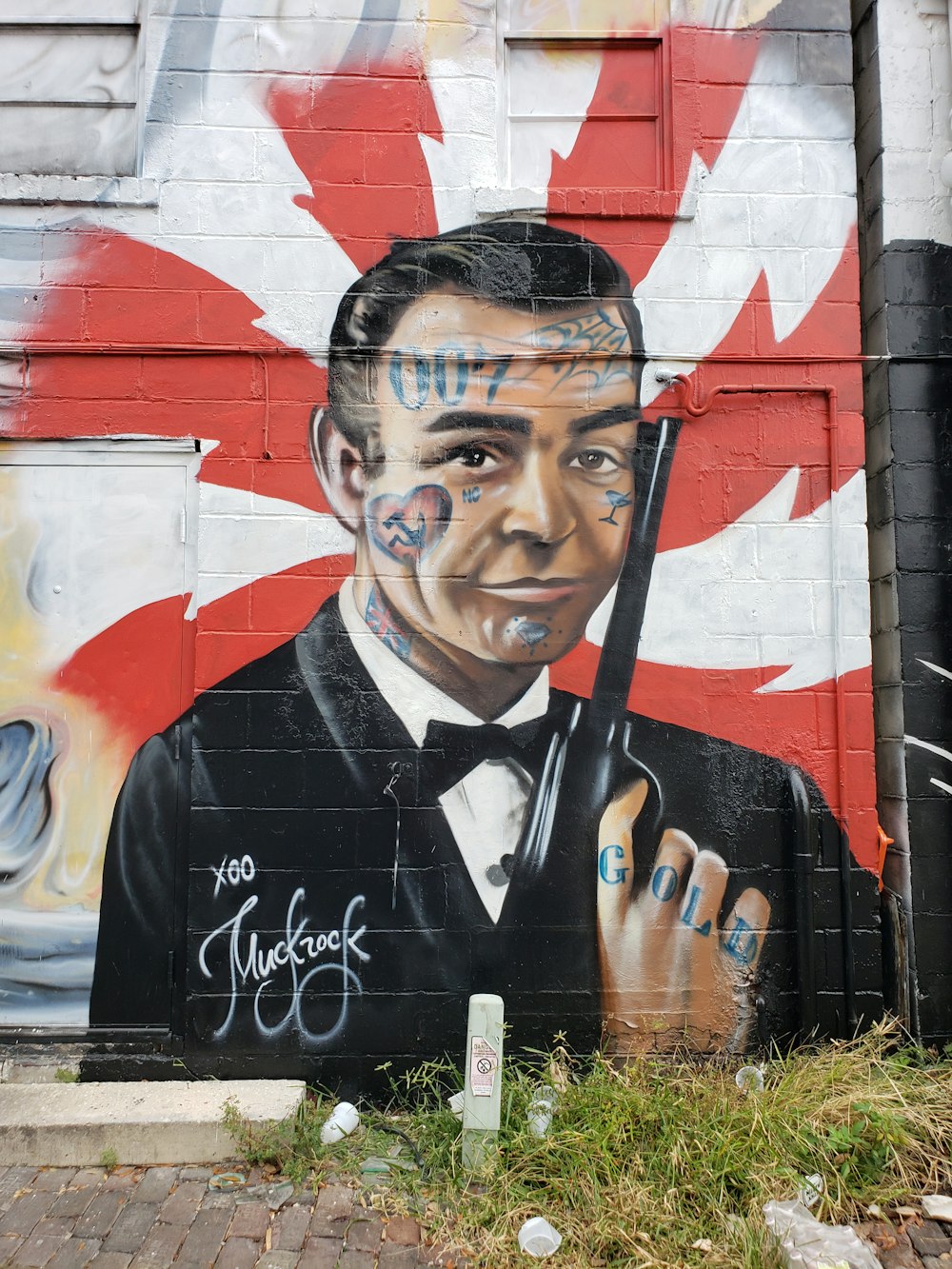 man in black suit jacket holding black rifle