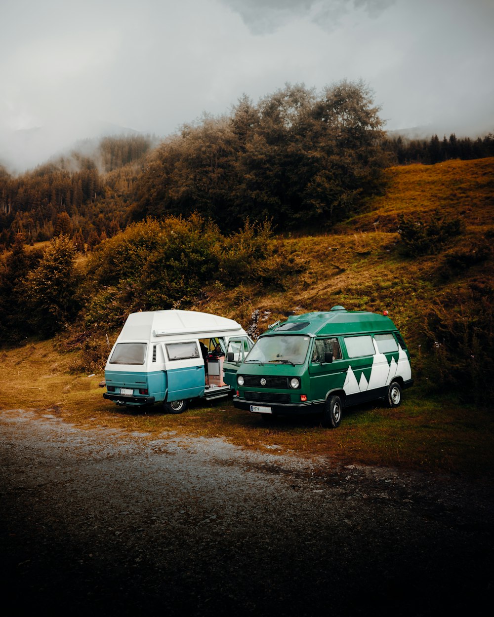 green and white van on brown dirt road during daytime