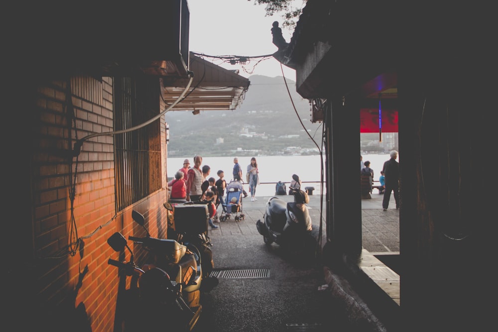 people sitting on chairs near sea during daytime