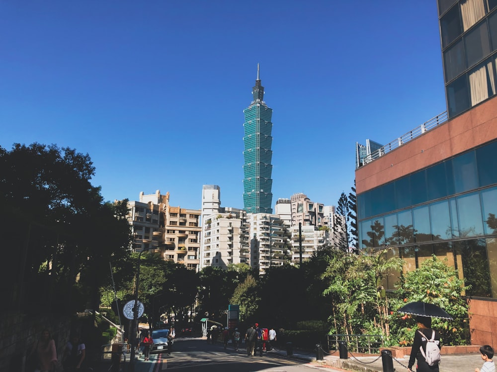 people walking on street near high rise buildings during daytime