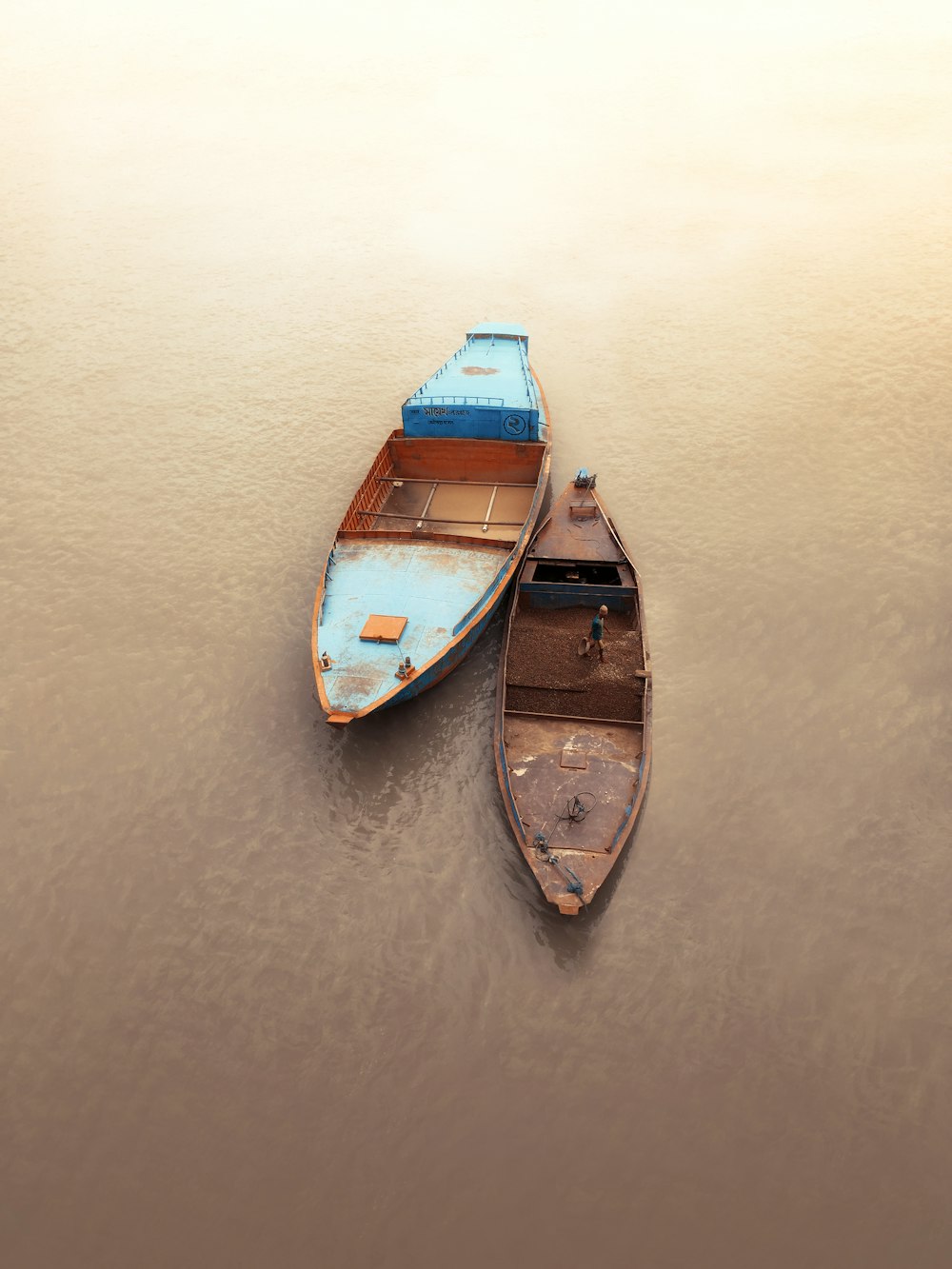 blue and brown wooden boat on body of water during daytime