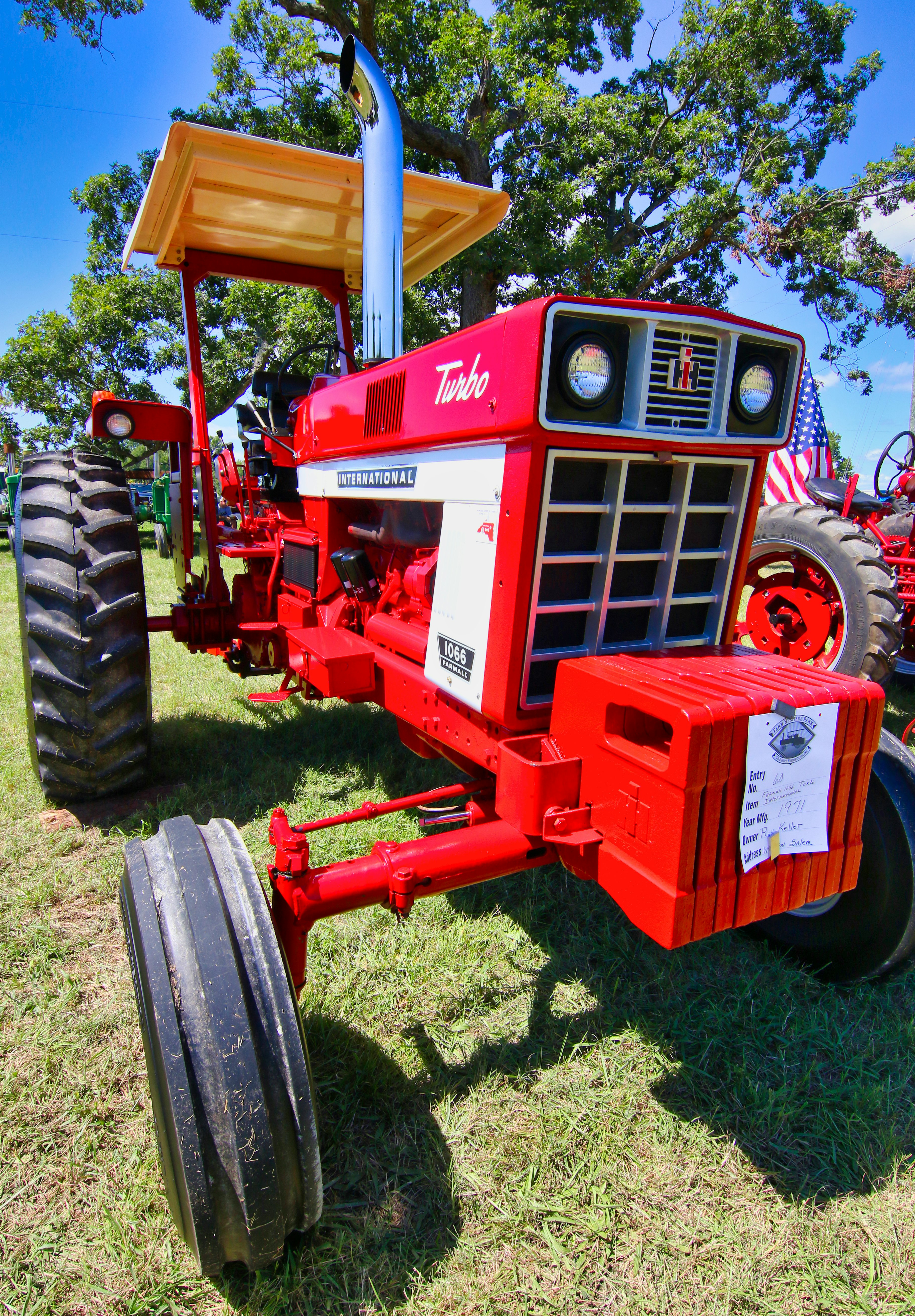 red and black tractor on green grass field during daytime