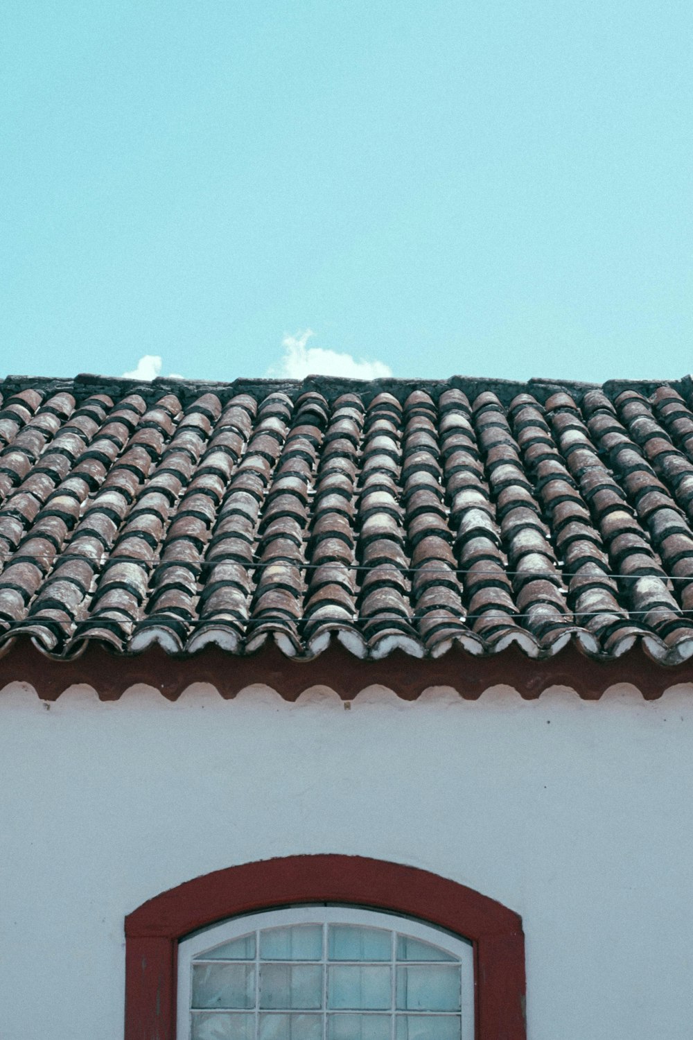 brown roof tiles under white sky during daytime