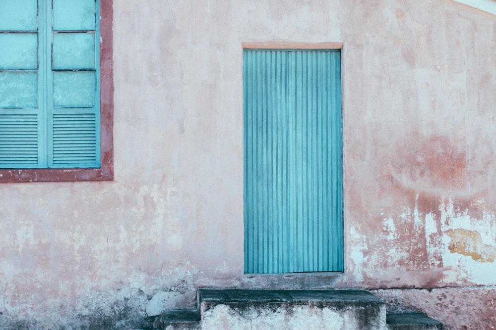 blue wooden door on gray concrete wall