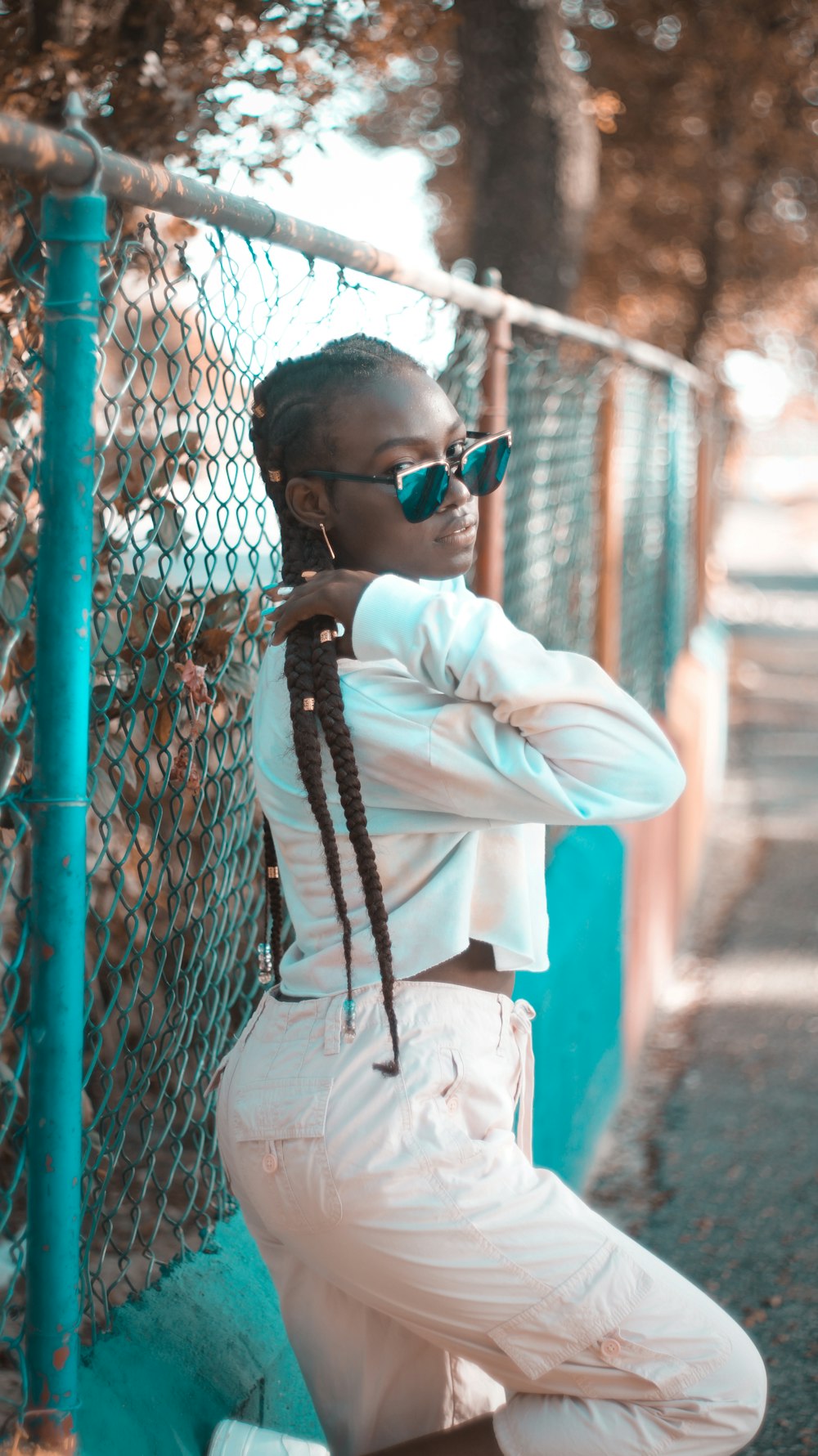 man in white dress shirt and white pants wearing black sunglasses