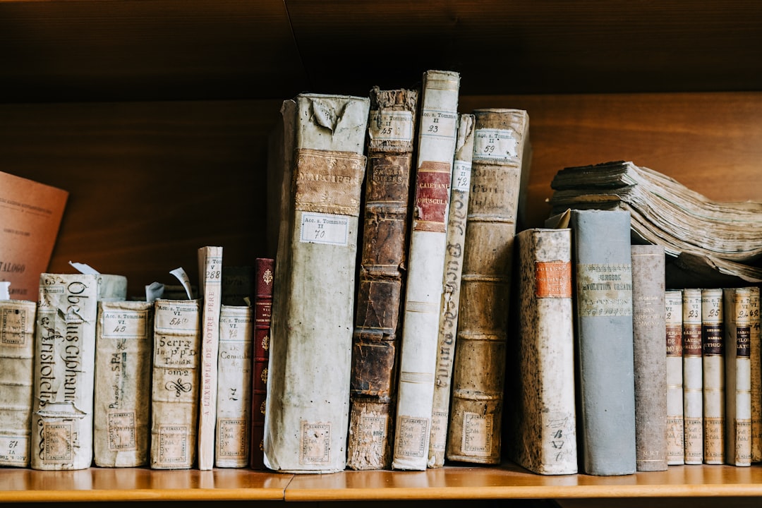 assorted books on brown wooden shelf, A bookshelf full of antique books