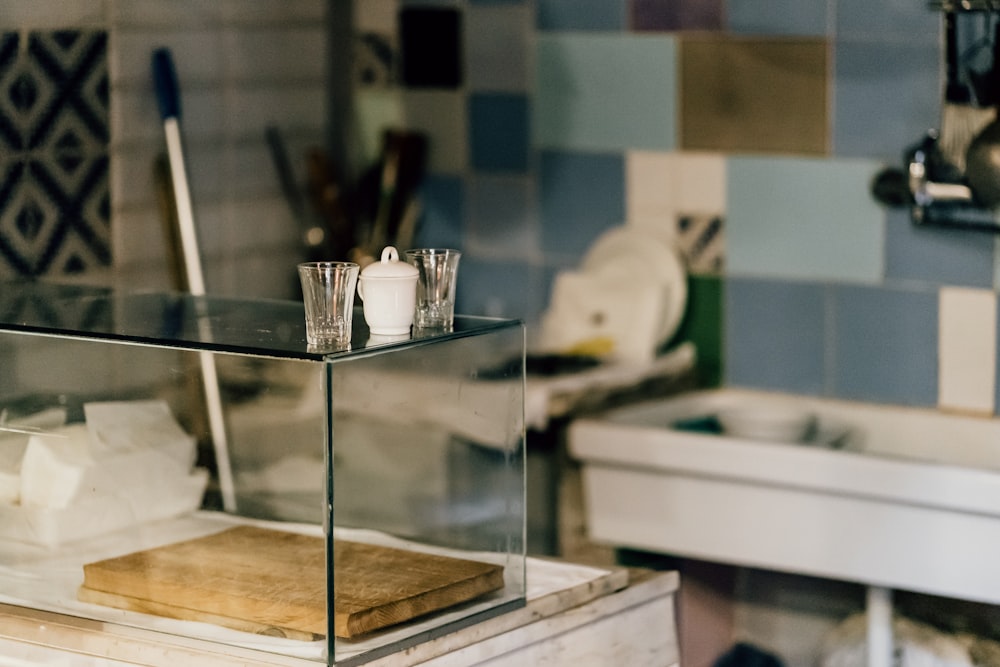 clear glass container on glass table